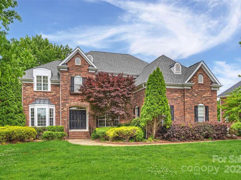 5940 Four Wood Drive, Matthews, NC 28104.  MLS# CAR4252079, YatesRealty ID 19844. Crisp curb appeal, mature landscaping, stately brick façade.