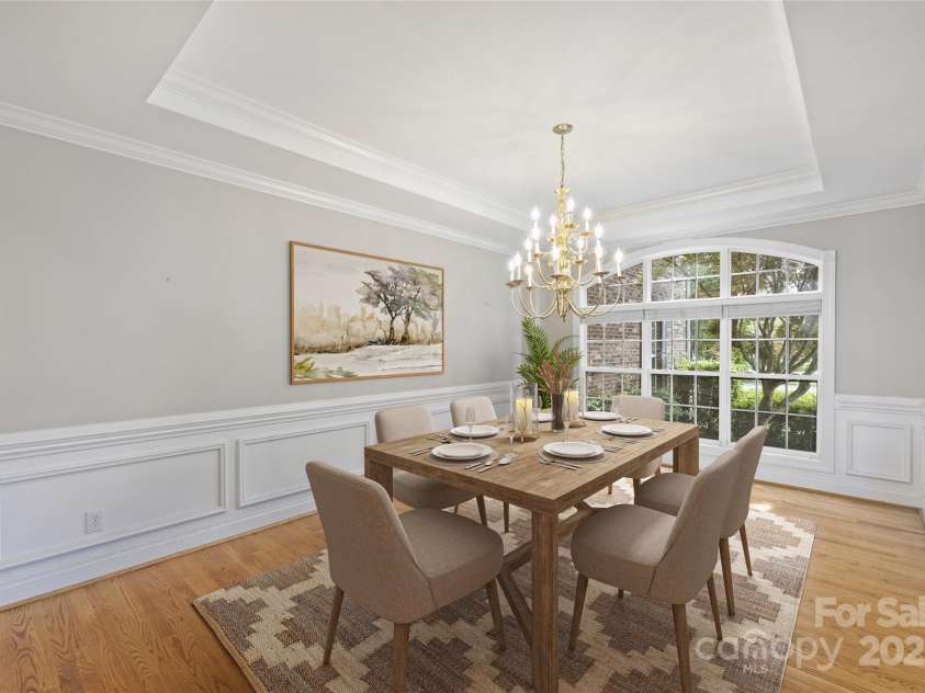 5940 Four Wood Drive, Matthews, NC 28104.  MLS# CAR4252079, YatesRealty ID 19844. Elegant formal dining framed by millwork—seats 8–10 comfortably; steps from kitchen for effortless hosting