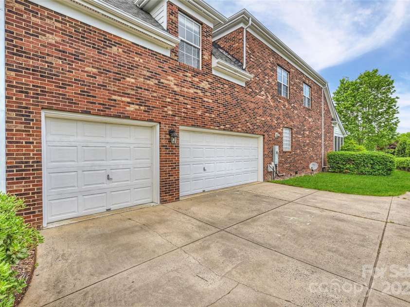 5940 Four Wood Drive, Matthews, NC 28104.  MLS# CAR4252079, YatesRealty ID 19844. Oversized 3-car garage with storage options—room for vehicles, gear, and hobbies.