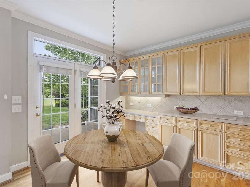 5940 Four Wood Drive, Matthews, NC 28104.  MLS# CAR4252079, YatesRealty ID 19844. Sunny breakfast nook overlooking the backyard—morning coffee with a view.