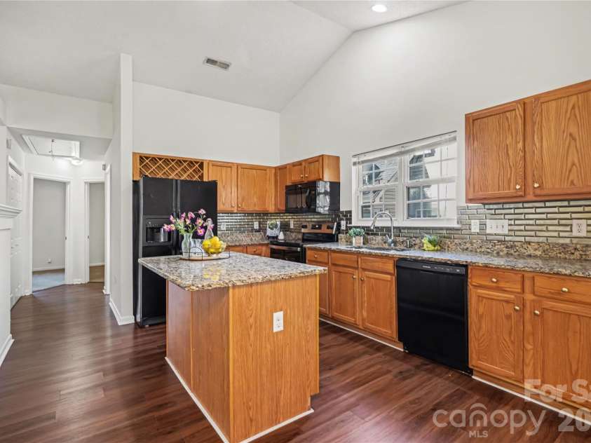 11709 BLACK MAPLE Avenue, Charlotte, NC 28269.  MLS# CAR4367081, YatesRealty ID 19850. Kitchen has black appliances and granite countertops