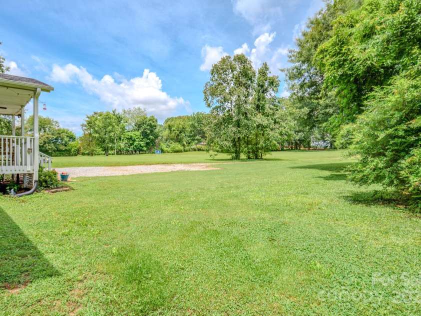 210 US 221A Highway, Forest City, NC 28043.  MLS# CAR4264127, YatesRealty ID 19853. Side yard