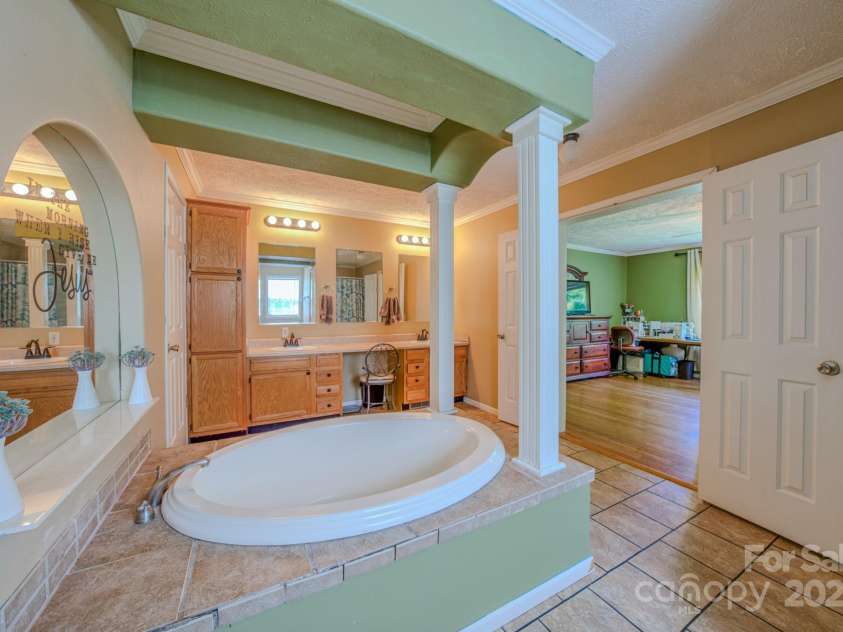 210 US 221A Highway, Forest City, NC 28043.  MLS# CAR4264127, YatesRealty ID 19853. Spacious Primary bath, ensuite with garden tub, dual vanities and stand alone shower.