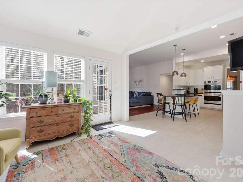 7135 Meyer Road, Fort Mill, SC 29715.  MLS# CAR4377464, YatesRealty ID 19864. Sunroom looking back  into kitchen and family room.