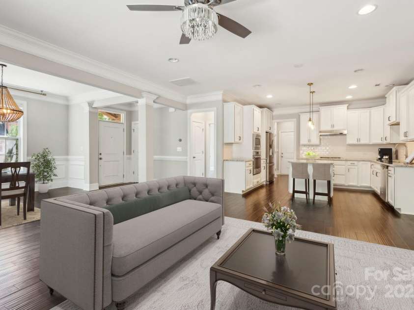 907 Ospre Lane, Fort Mill, SC 29708.  MLS# CAR4254427, YatesRealty ID 19864. Virtually staged - family room, dining, and kitchen