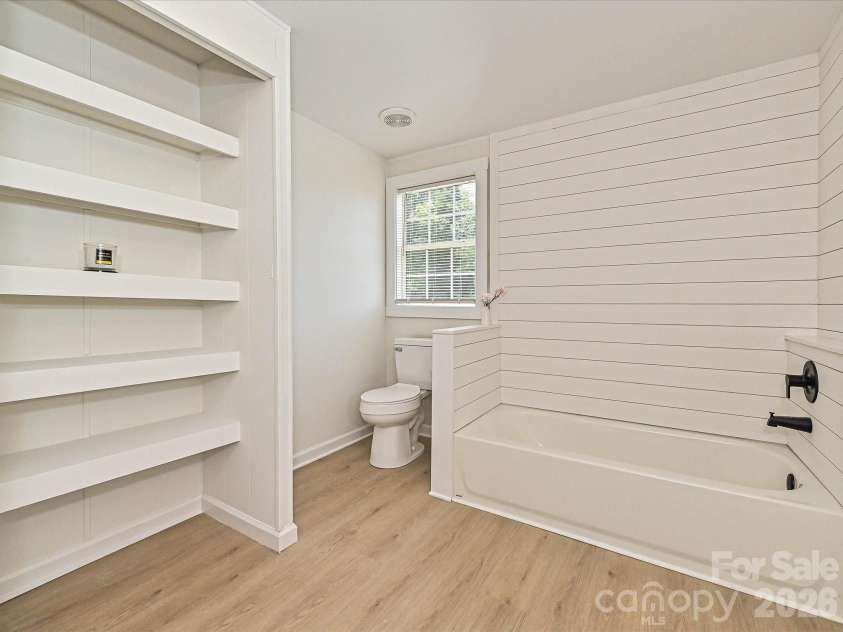 4076 Ritchfield Drive, Lincolnton, NC 28092.  MLS# CAR4376979, YatesRealty ID 19865. Primary en-suite custom shelving, commode, bath tub, shiplap, etc. 