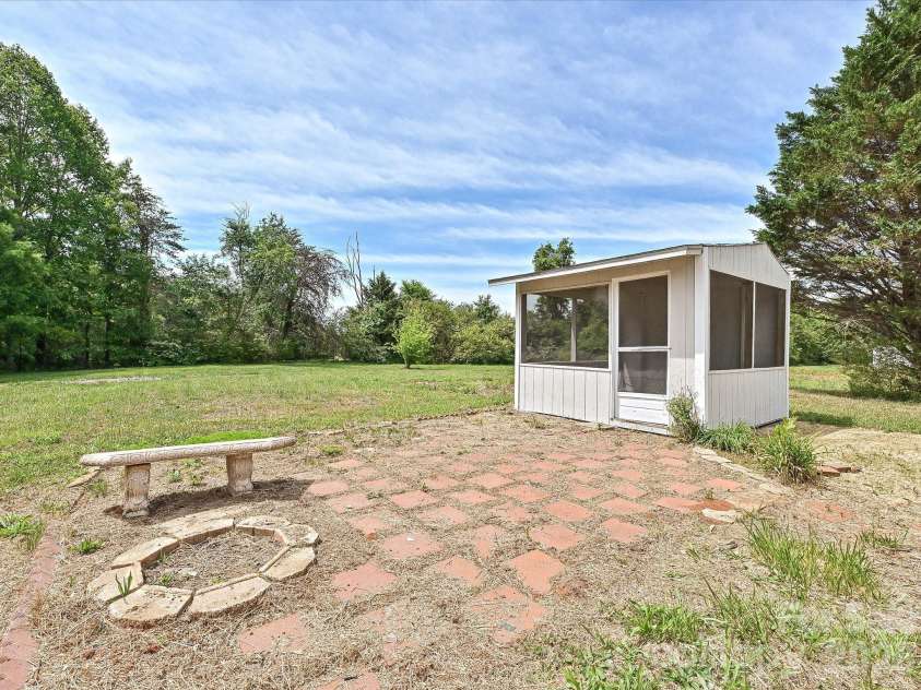 4076 Ritchfield Drive, Lincolnton, NC 28092.  MLS# CAR4376979, YatesRealty ID 19865. View of detached screened in shed with patio and firepit. 