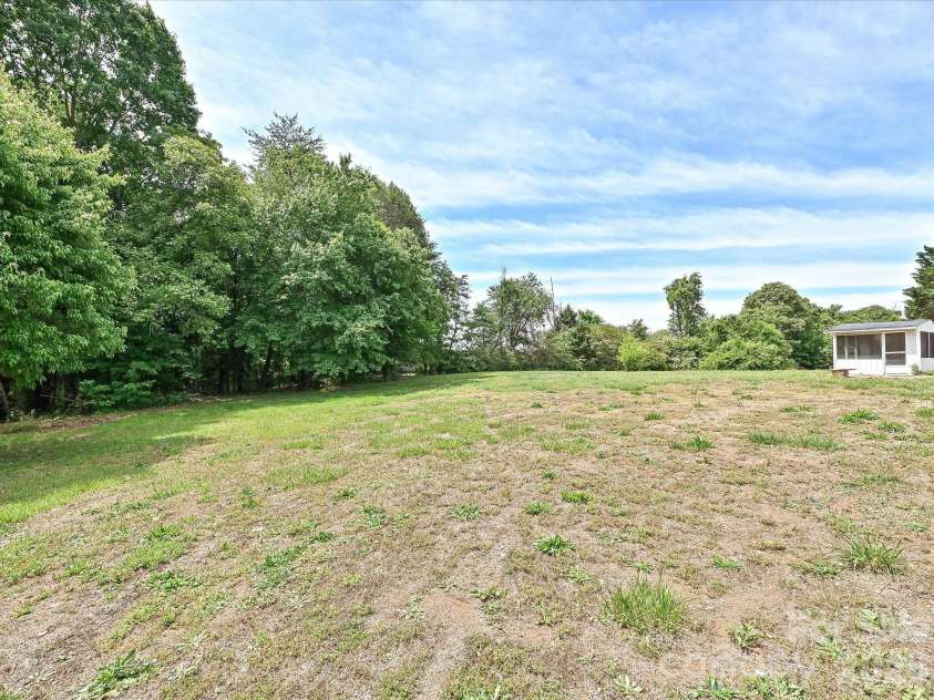4076 Ritchfield Drive, Lincolnton, NC 28092.  MLS# CAR4376979, YatesRealty ID 19865. View of huge backyard, trees (forest) and pasture behind. 