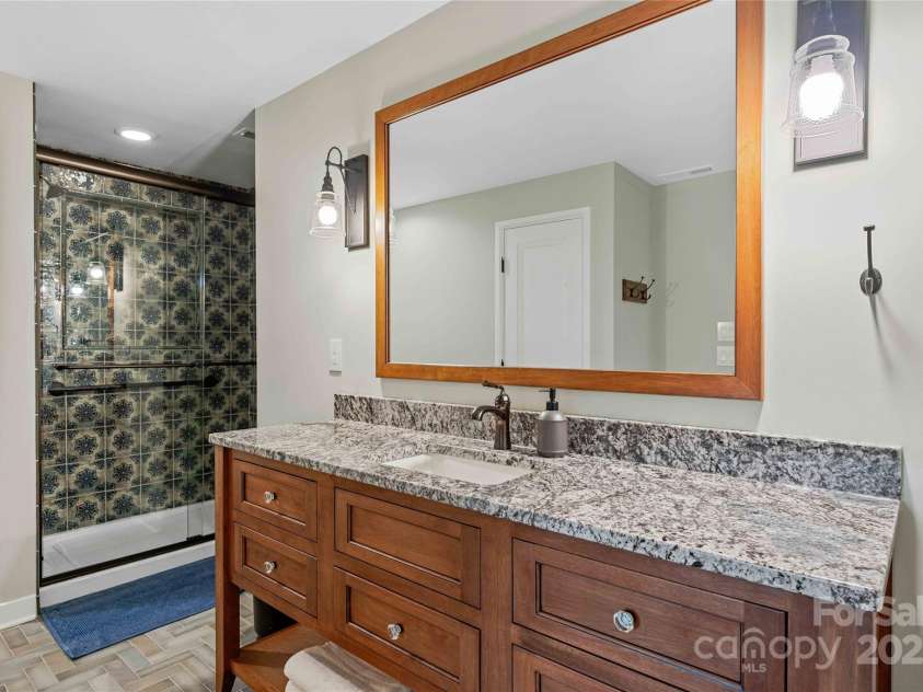 400 Kings Drive, Lake Lure, NC 28746.  MLS# CAR4264882, YatesRealty ID 19869. Freshly updated bathroom tile, vanities and tile flooring throughout.