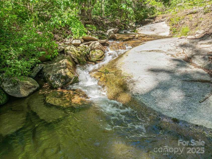 400 Kings Drive, Lake Lure, NC 28746.  MLS# CAR4264882, YatesRealty ID 19869. Multiple spring fed creek pools to play and soak in the warm summer afternoons.