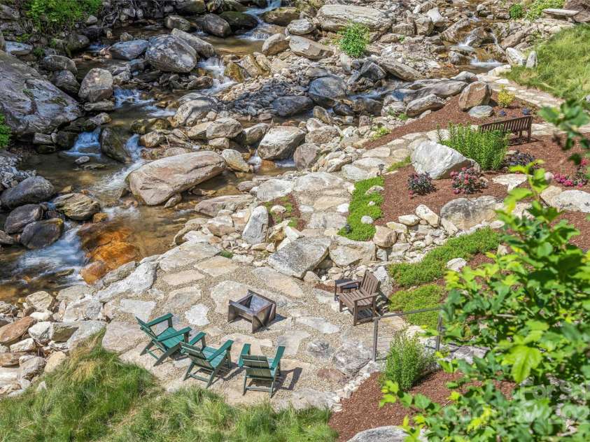 400 Kings Drive, Lake Lure, NC 28746.  MLS# CAR4264882, YatesRealty ID 19869. Owners have created a lower streamside entertaining area with fire pit and multiple seating areas.