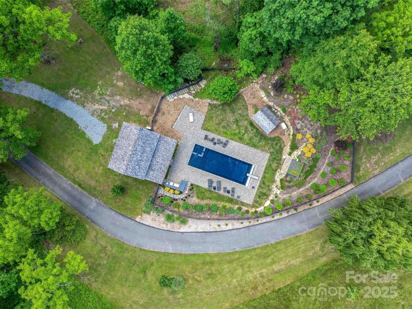 400 Kings Drive, Lake Lure, NC 28746.  MLS# CAR4264882, YatesRealty ID 19869. Thoughtfully laid out pool, outdoor grill and entertaining area as well as full sized heated pool, hot tub and structure ready to complete into a sauna.