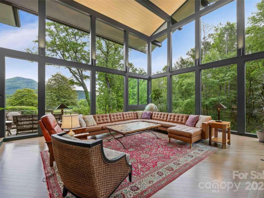 400 Kings Drive, Lake Lure, NC 28746.  MLS# CAR4329275, YatesRealty ID 19869. Livingroom is wide open to nature with the sound of the flowing stream cascading below.