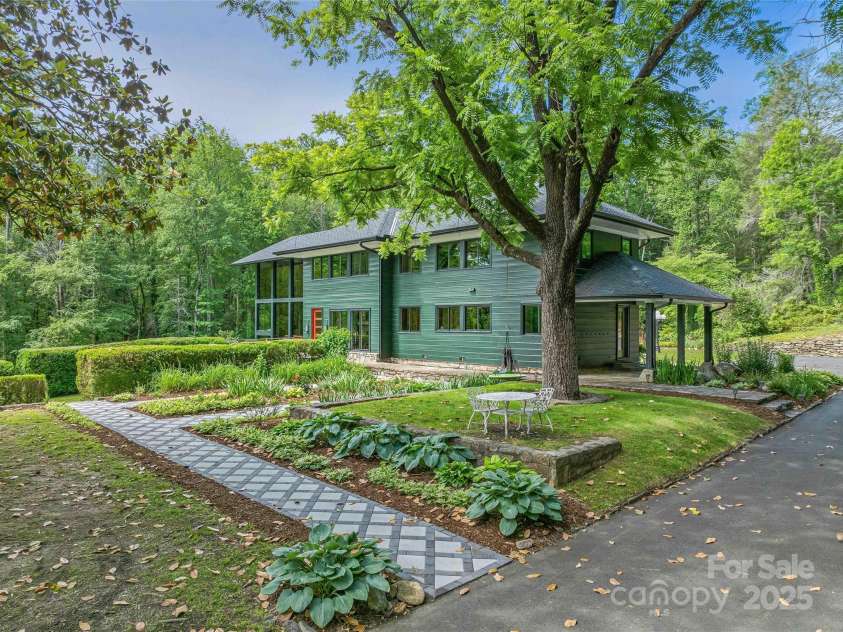 400 Kings Drive, Lake Lure, NC 28746.  MLS# CAR4329275, YatesRealty ID 19869. Manicured blooming entry garden pathway with Magnolia and Walnut trees provide shade in the Summer months