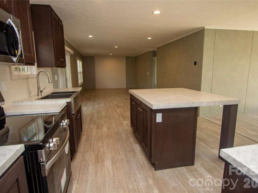 36 Whisper Mountain Road, Hendersonville, NC 28792.  MLS# CAR4373855, YatesRealty ID 19872. Great Room with Dining Area & deck access