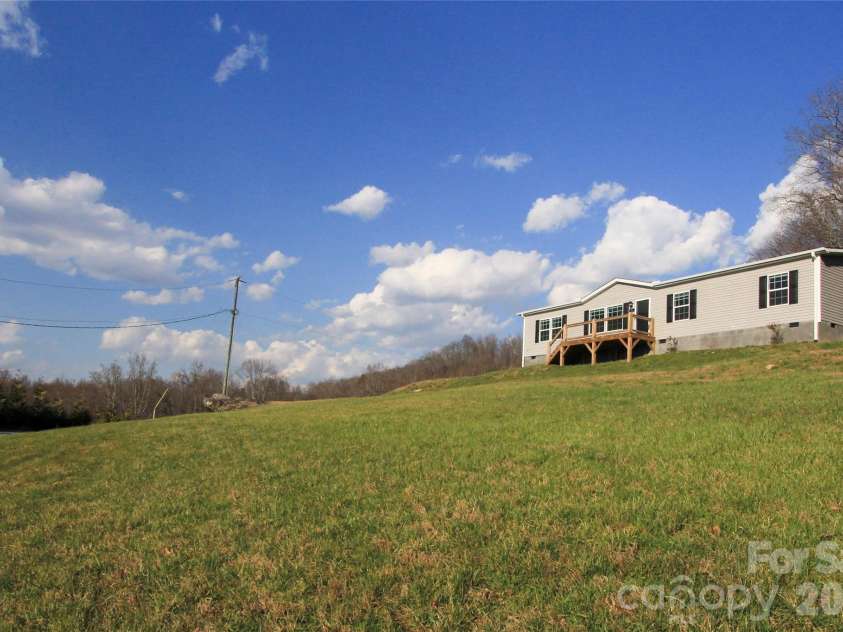 36 Whisper Mountain Road, Hendersonville, NC 28792.  MLS# CAR4373855, YatesRealty ID 19872. Huge West facing front lawn