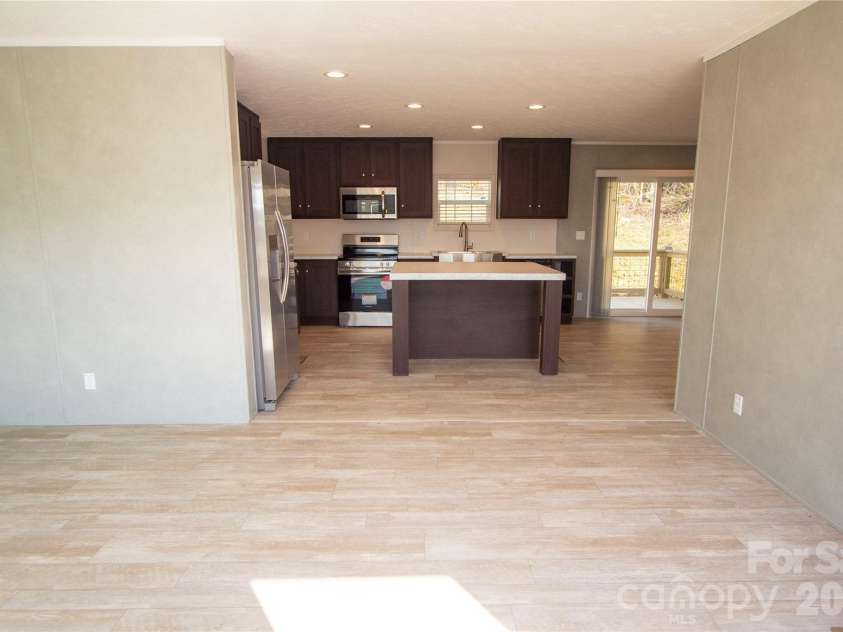 36 Whisper Mountain Road, Hendersonville, NC 28792.  MLS# CAR4373855, YatesRealty ID 19872. Living Room towards Kitchen & Dining Area