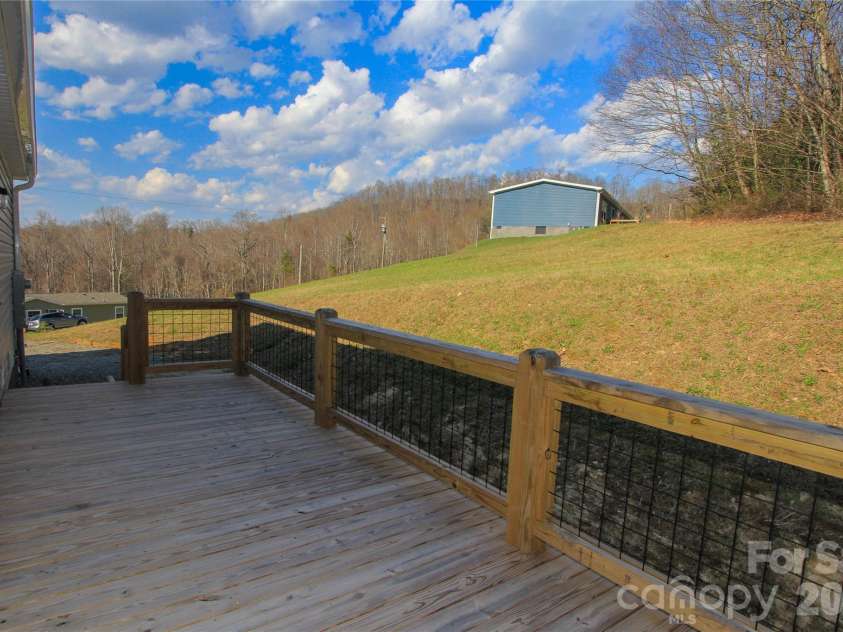36 Whisper Mountain Road, Hendersonville, NC 28792.  MLS# CAR4373855, YatesRealty ID 19872. Rear Deck w/ door to  Mudroom