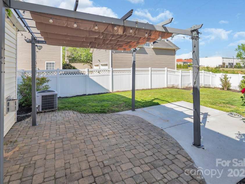 18023 Train Station Drive, Cornelius, NC 28031.  MLS# CAR4198417, YatesRealty ID 19875. Charming shade cover, perfect to dine under.