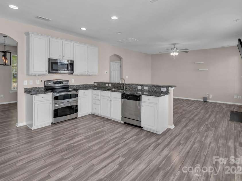 18023 Train Station Drive, Cornelius, NC 28031.  MLS# CAR4198417, YatesRealty ID 19875. Kitchen has eat-in bar and opens to the family room.