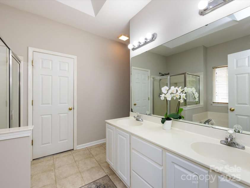 1423 Piper Court, Concord, NC 28025.  MLS# CAR4269356, YatesRealty ID 19879. Primary bath with dual vanity and access to large walk in closet with window