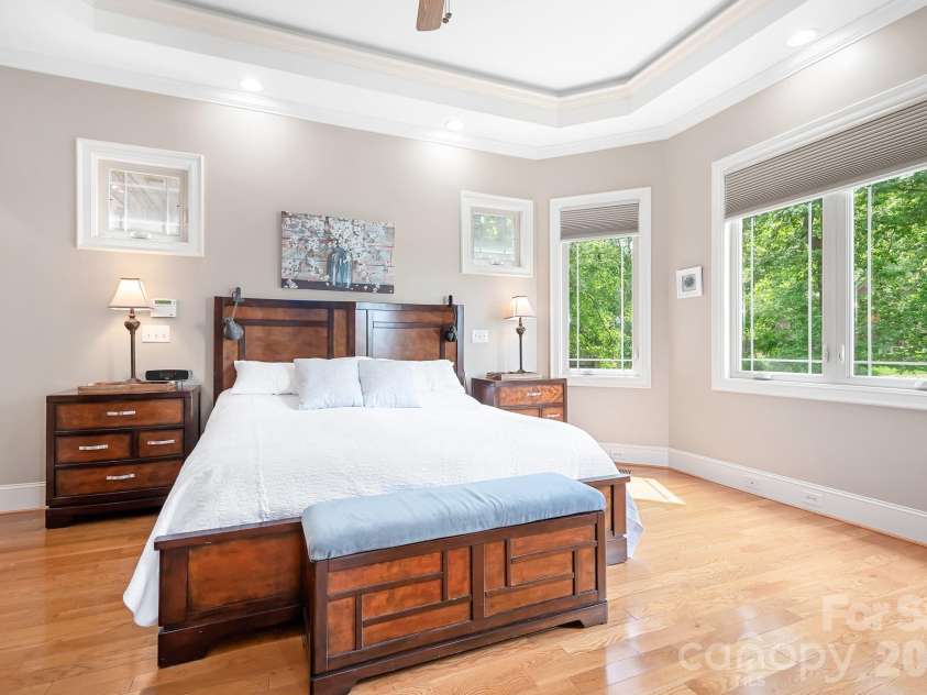 1395 Strawberry Lane, Denver, NC 28037.  MLS# CAR4370070, YatesRealty ID 19880. Perfectly sized primary bedroom.  Tiered ceiling with accent lights, lakeside and poolside views, separate entrance to outdoor covered porch overlooking the rear yard and pool.