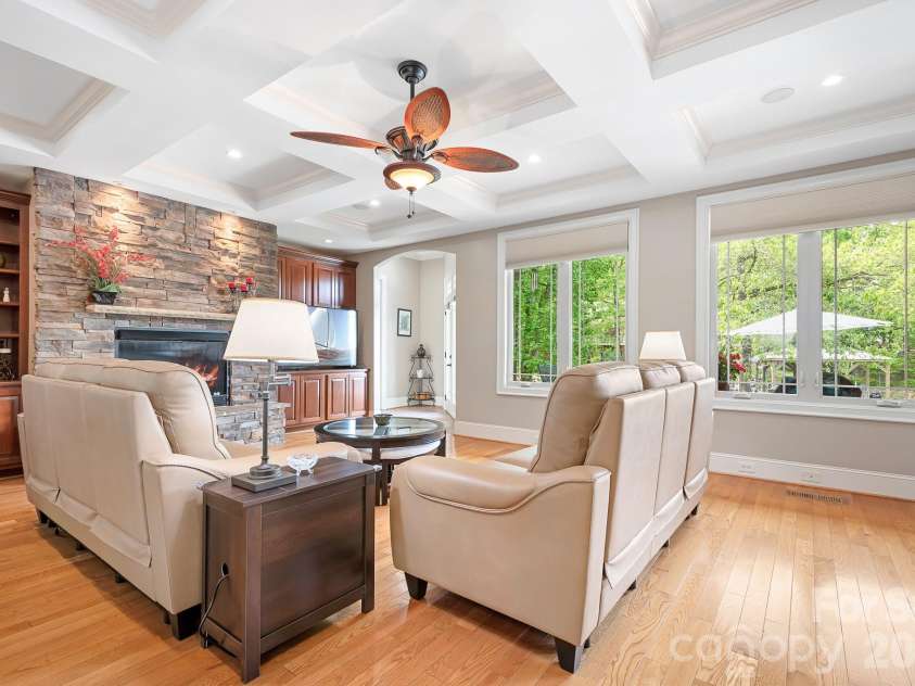 1395 Strawberry Lane, Denver, NC 28037.  MLS# CAR4370070, YatesRealty ID 19880. Spacious great room with dramatic coffered ceiling, stone fireplace, built ins, lots of windows for light and scenery. Open to,the kitchen, eat in area as well as a dedicated office.