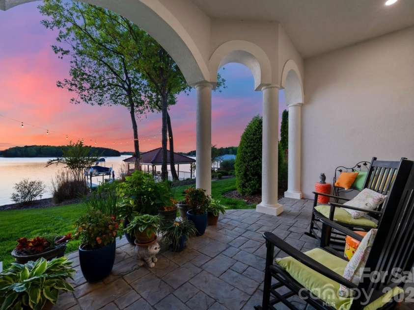 18103 Harbor Light Boulevard, Cornelius, NC 28031.  MLS# CAR4361515, YatesRealty ID 19890. Covered lakeside terrace capturing breathtaking west-facing sunset views
