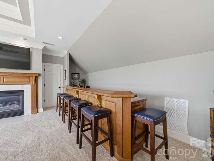 18103 Harbor Light Boulevard, Cornelius, NC 28031.  MLS# CAR4361515, YatesRealty ID 19890. Custom built-in bar with seating, perfect for entertaining and gathering