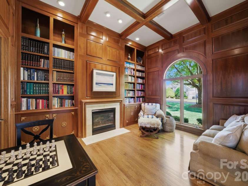 18103 Harbor Light Boulevard, Cornelius, NC 28031.  MLS# CAR4361515, YatesRealty ID 19890. Elegant Brazilian cherry wood library with custom millwork and fireplace