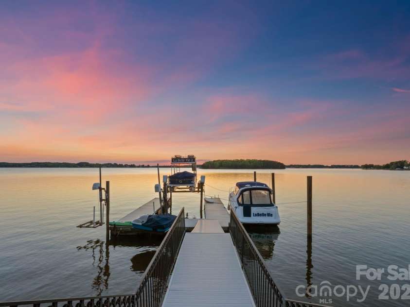 18103 Harbor Light Boulevard, Cornelius, NC 28031.  MLS# CAR4361515, YatesRealty ID 19890. Private dock with multiple slips and lifts, offering immediate access to deep water on Lake Norman