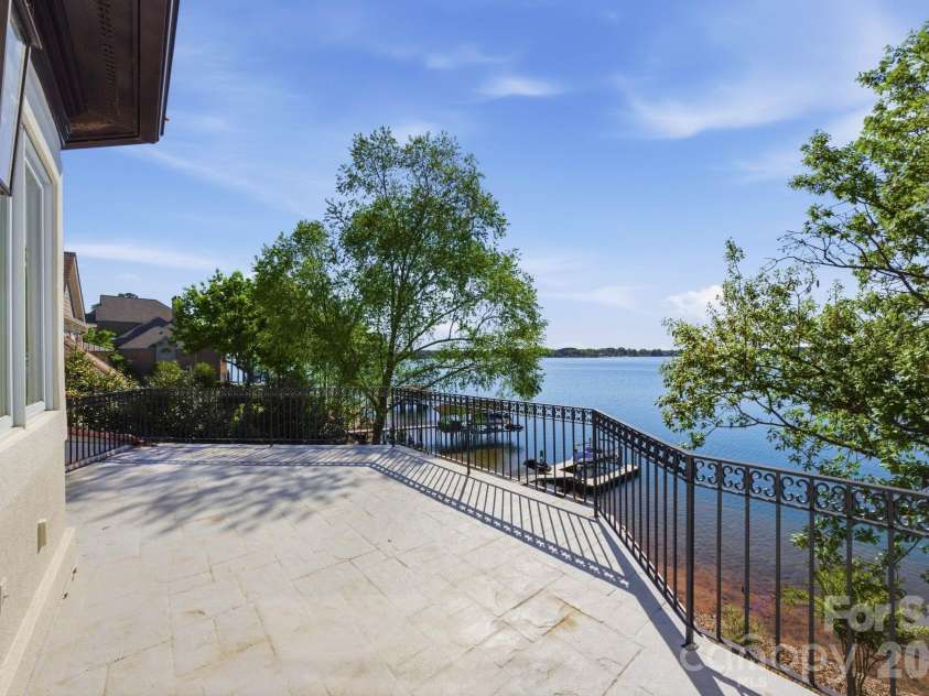 18103 Harbor Light Boulevard, Cornelius, NC 28031.  MLS# CAR4361515, YatesRealty ID 19890. Private terrace off the primary suite with tranquil lake views