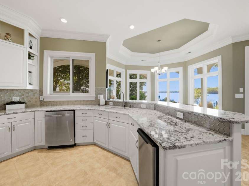 18103 Harbor Light Boulevard, Cornelius, NC 28031.  MLS# CAR4361515, YatesRealty ID 19890. Secondary kitchen with granite surfaces and seamless access to outdoor living