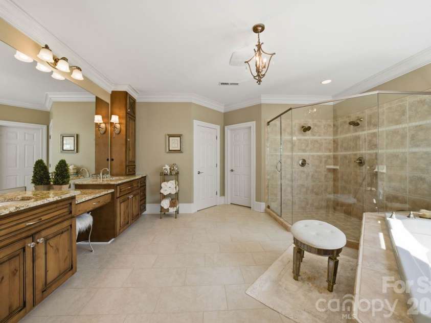 18103 Harbor Light Boulevard, Cornelius, NC 28031.  MLS# CAR4361515, YatesRealty ID 19890. Spa-inspired primary bath with dual vanities, soaking tub, and oversized walk-in shower