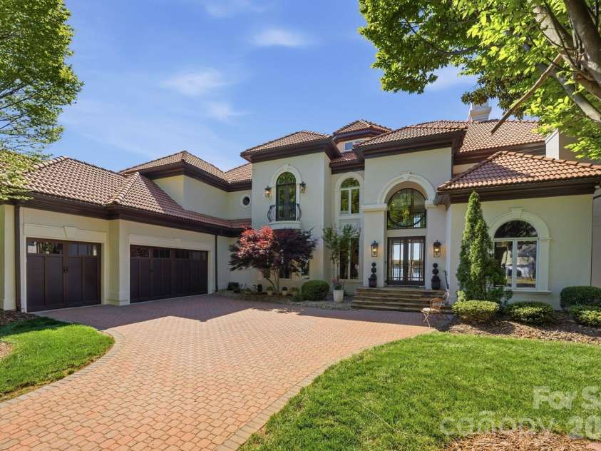 18103 Harbor Light Boulevard, Cornelius, NC 28031.  MLS# CAR4361515, YatesRealty ID 19890. Stately Mediterranean-inspired architecture with elegant paver driveway and inviting entry