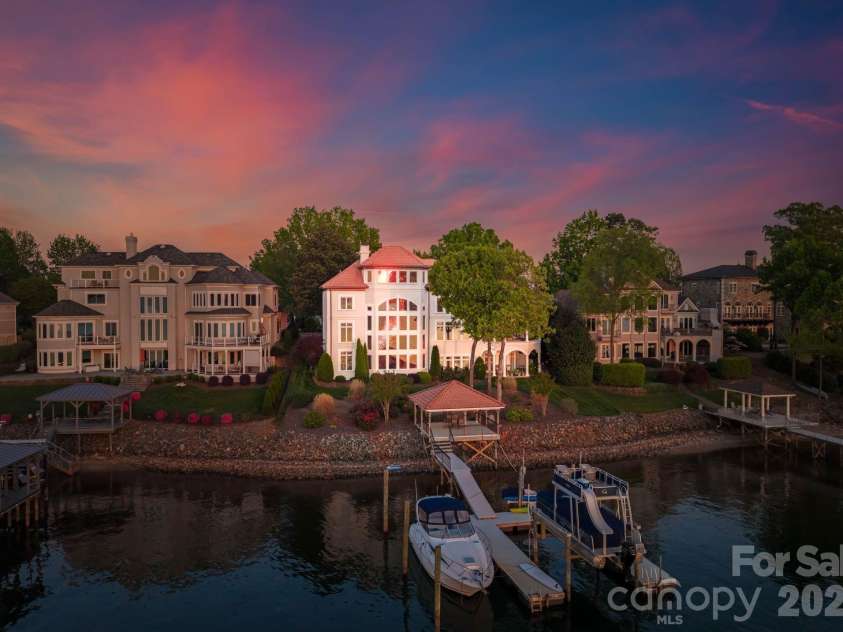 18103 Harbor Light Boulevard, Cornelius, NC 28031.  MLS# CAR4361515, YatesRealty ID 19890. Stunning lakeside elevation with dramatic architectural lines and walls of glass designed to capture panoramic water views