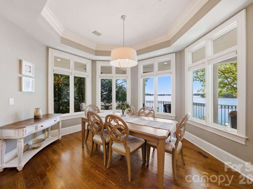 18103 Harbor Light Boulevard, Cornelius, NC 28031.  MLS# CAR4361515, YatesRealty ID 19890. Sunlit breakfast area framed by panoramic lake views and surrounding nature