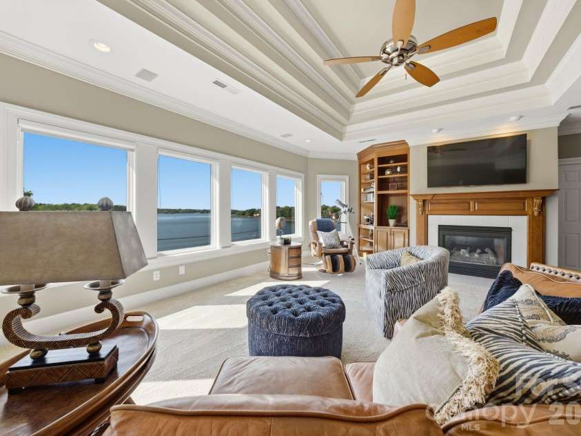18103 Harbor Light Boulevard, Cornelius, NC 28031.  MLS# CAR4361515, YatesRealty ID 19890. Upper-level lounge with panoramic lake views, fireplace, built-ins, and custom bar