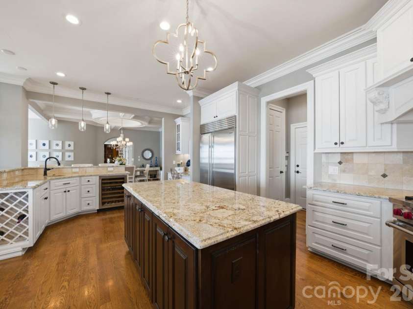 18103 Harbor Light Boulevard, Cornelius, NC 28031.  MLS# CAR4361515, YatesRealty ID 19890. Well-appointed kitchen with custom cabinetry and integrated wine storage