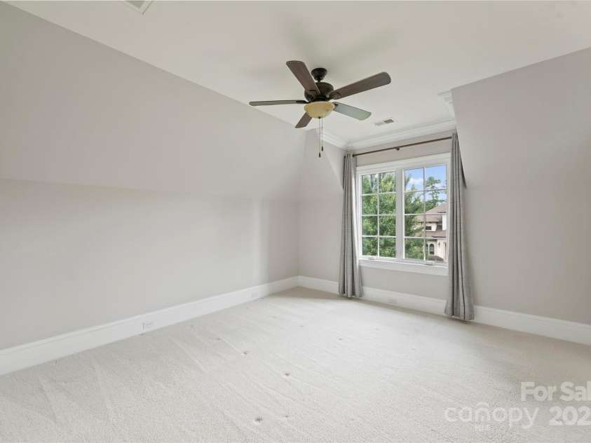 3032 Kings Manor Drive, Matthews, NC 28104.  MLS# CAR4265351, YatesRealty ID 19894. Bedroom 4 is also spacious, and features an en suite bathroom.