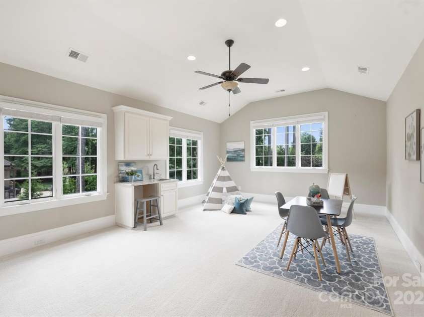 3032 Kings Manor Drive, Matthews, NC 28104.  MLS# CAR4265351, YatesRealty ID 19894. The bonus room is spacious and bright and sunny - there are lots of possibilities for this room - playroom, workout room, pool table, media center, etc.  This room also features built-in cabinetry for a wet bar and s