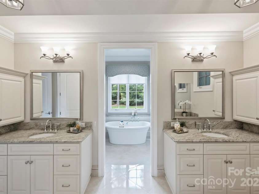 3032 Kings Manor Drive, Matthews, NC 28104.  MLS# CAR4265351, YatesRealty ID 19894. The free-standing garden bathtup is framed beautifully under the window.