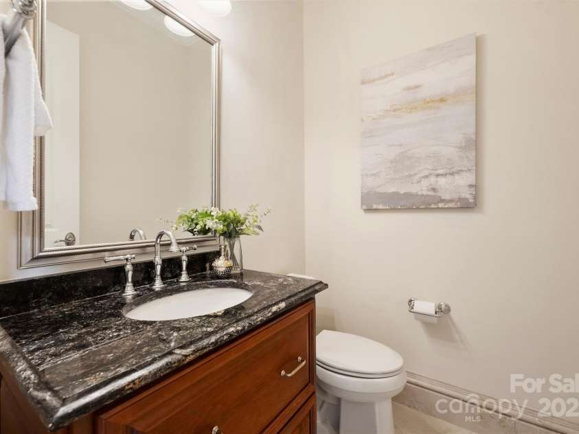 3032 Kings Manor Drive, Matthews, NC 28104.  MLS# CAR4265351, YatesRealty ID 19894. The powder room is centered nicely off the entrance hallway.