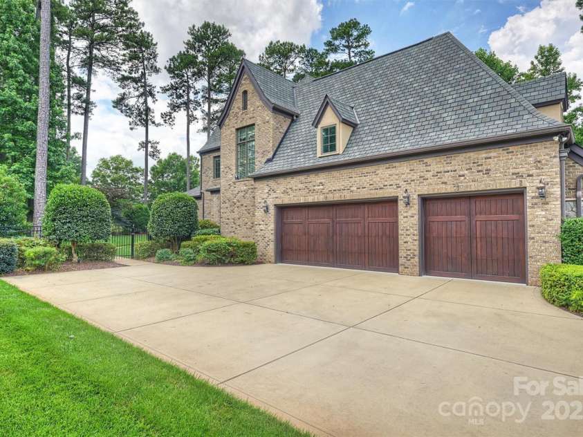 3032 Kings Manor Drive, Matthews, NC 28104.  MLS# CAR4265351, YatesRealty ID 19894. There's plenty of parking with the 3-car garage and enlarged parking pad.