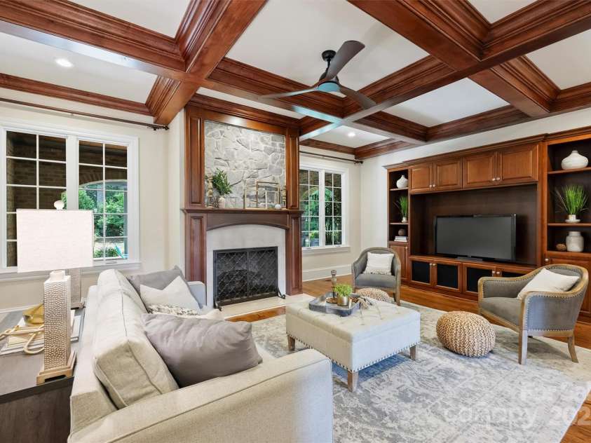 3032 Kings Manor Drive, Matthews, NC 28104.  MLS# CAR4265351, YatesRealty ID 19894. This cozy and inviting Great Room features a beautiful coffered ceiling and new stone inlay over the fireplace.  The built-ins will accommodate an 85