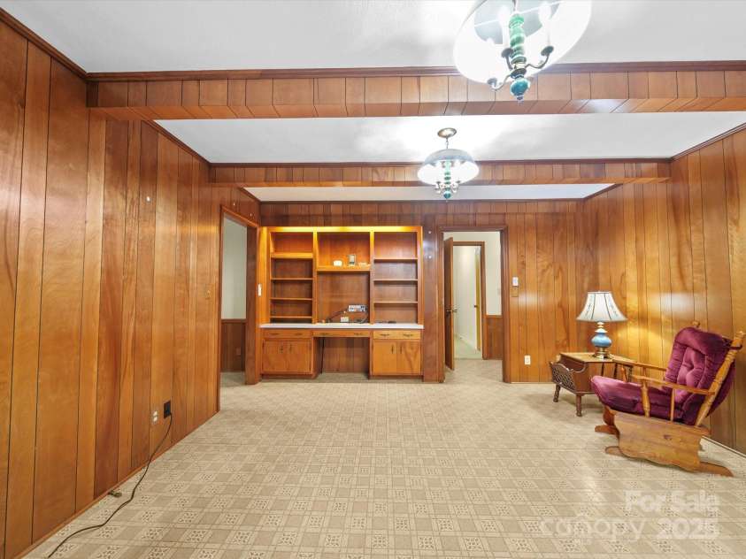2831 Puetts Chapel Road, Bessemer City, NC 28016.  MLS# CAR4268907, YatesRealty ID 19907. Den/family room with built-ins and solid wood paneling.