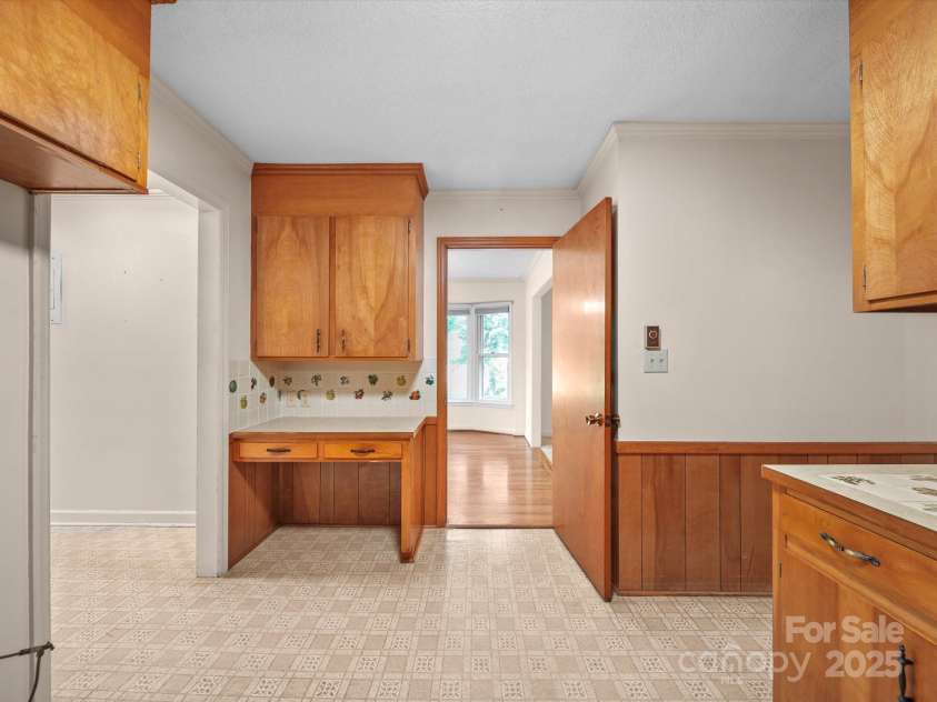 2831 Puetts Chapel Road, Bessemer City, NC 28016.  MLS# CAR4268907, YatesRealty ID 19907. Dining room leads to the kitchen which includes a custom built-in desk.