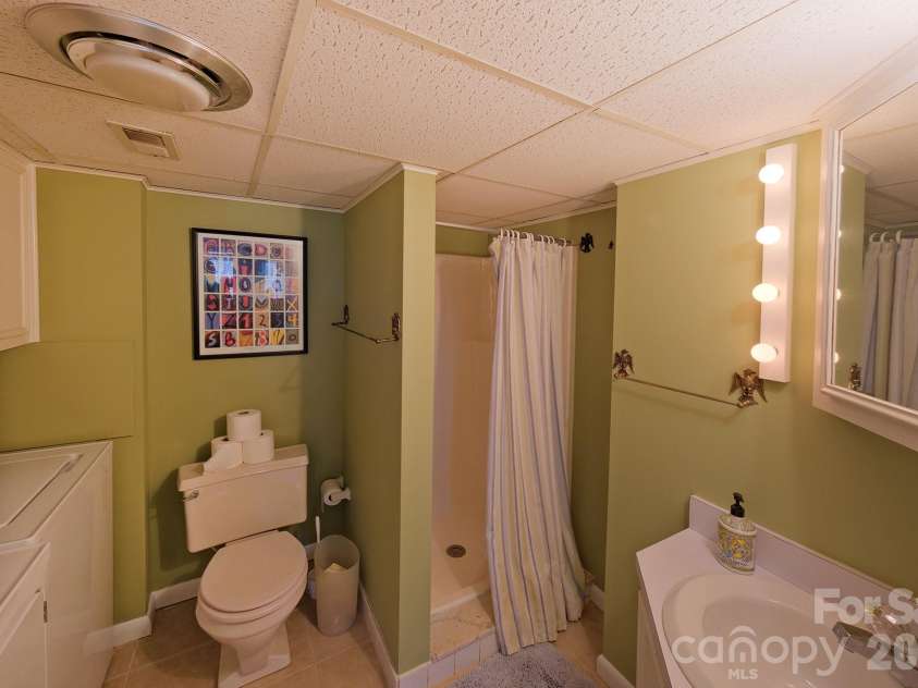 71 Norfolk Lane, Laurel Park, NC 28739.  MLS# CAR4345352, YatesRealty ID 19912. Full bath, laundry area- lower level