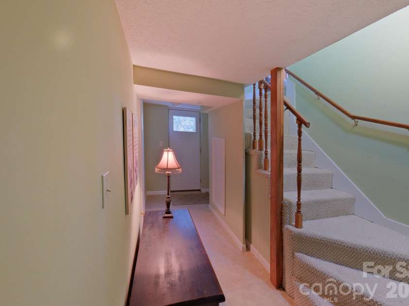 71 Norfolk Lane, Laurel Park, NC 28739.  MLS# CAR4345352, YatesRealty ID 19912. Inside stairs to the lower level (basement)