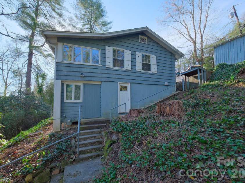 71 Norfolk Lane, Laurel Park, NC 28739.  MLS# CAR4345352, YatesRealty ID 19912. Side view - outside entrance to the basement